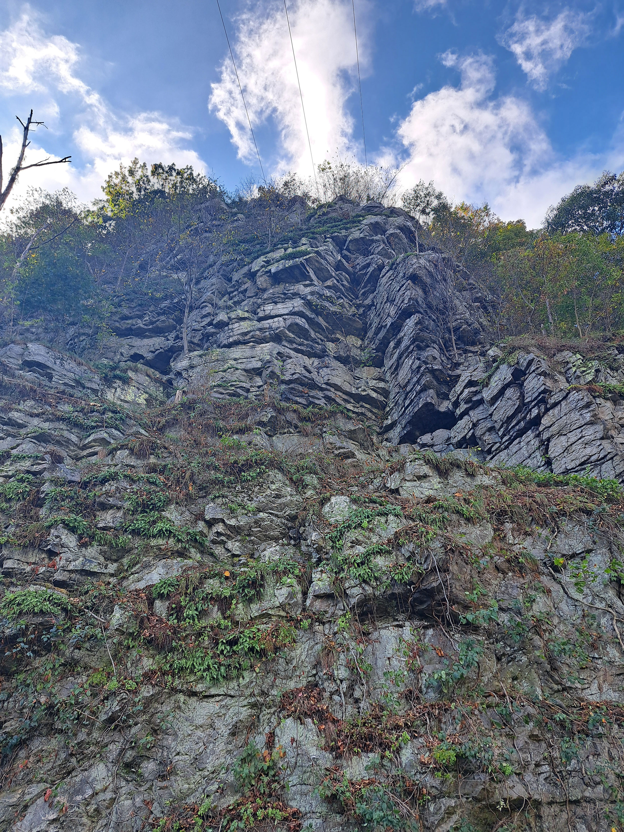 Photo is of an overhanging rock near the top of the slope above US 340.