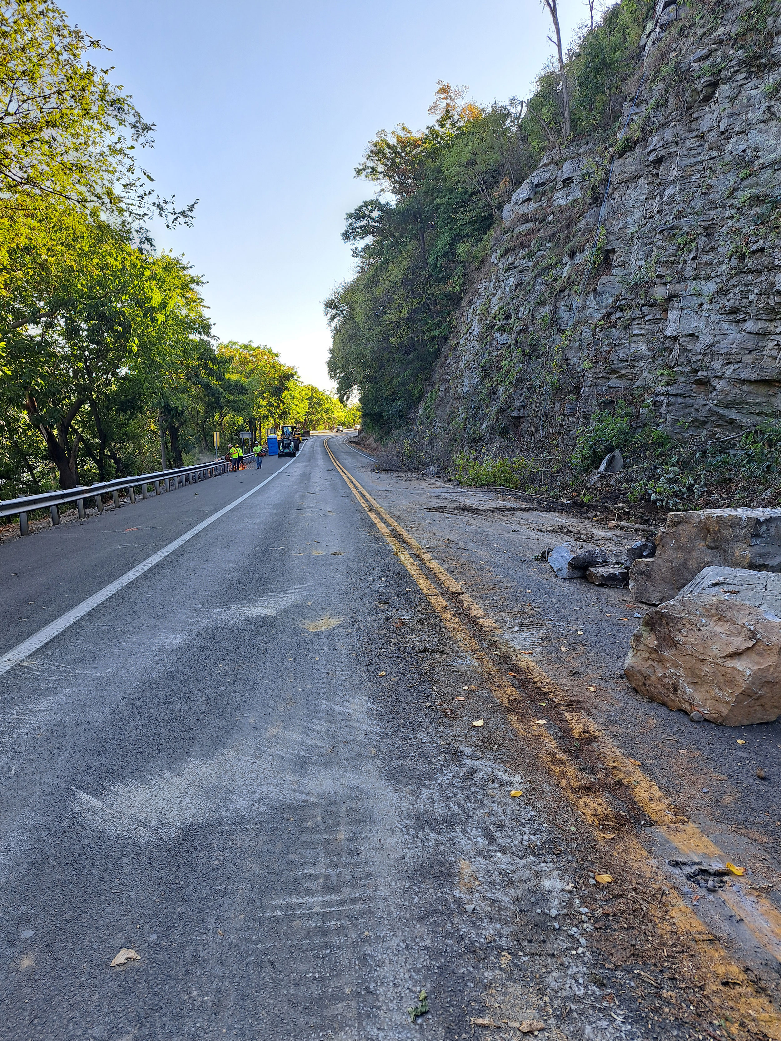 Photo shows the removal of loose rocks at the bottom of the slope onto US 340.  Impacts from rock removal is visible on the US 340 roadway surface.