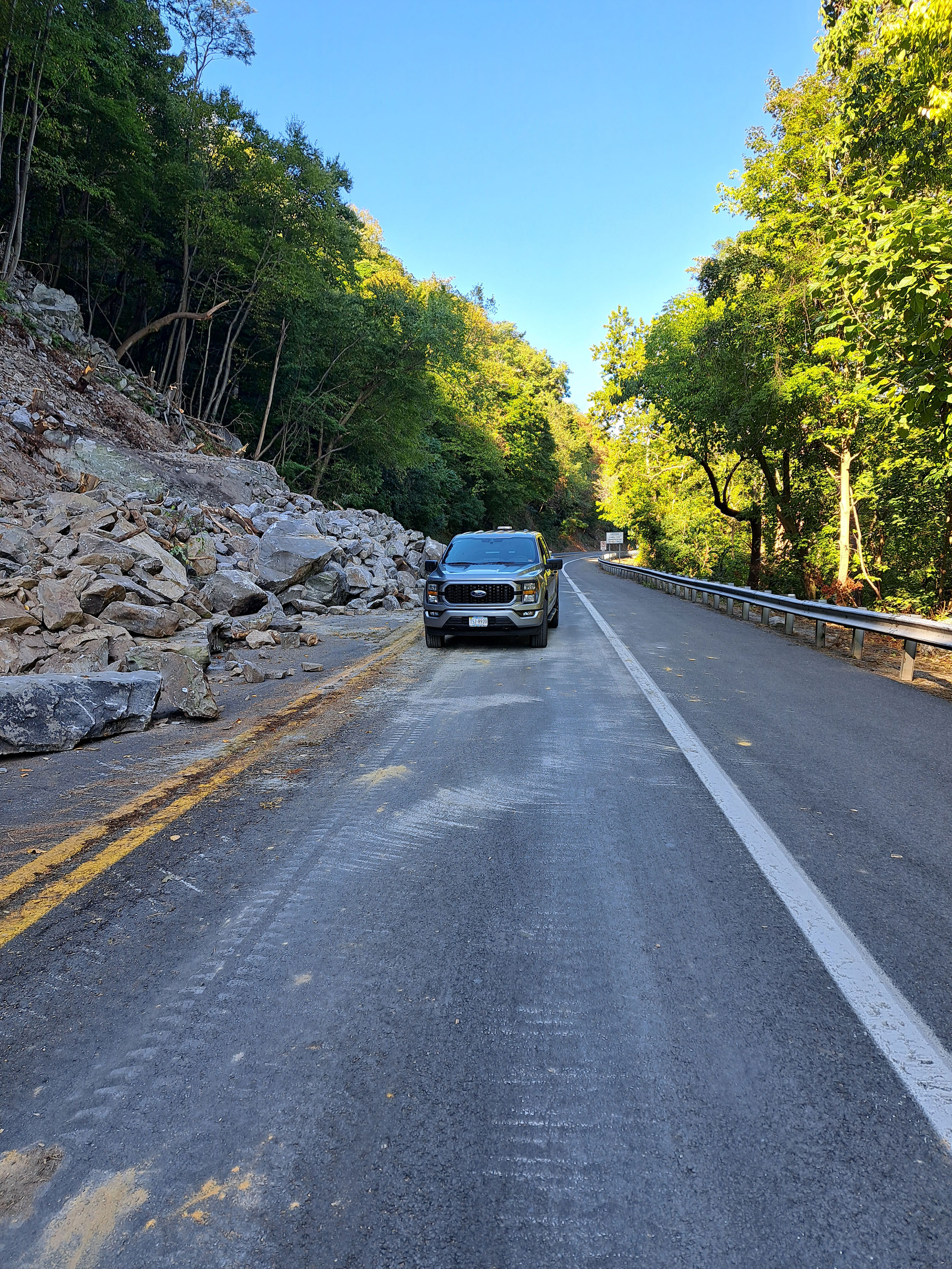 Photo shows the loose rocks removed from the slopes which have fallen onto US 340.